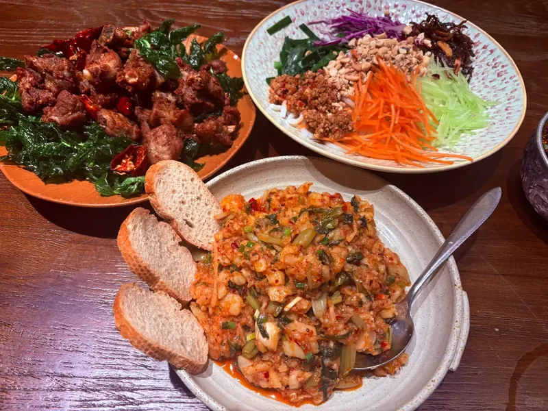 A table spread of traditional Bai dishes in Dali