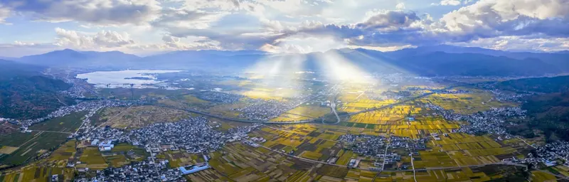 Dawn light over fields and cloud seen from the Cangshan Mountains